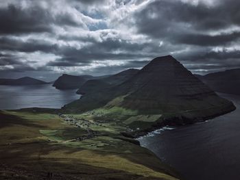 Scenic view of sea and mountains against sky