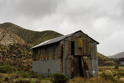 Old building on field against sky