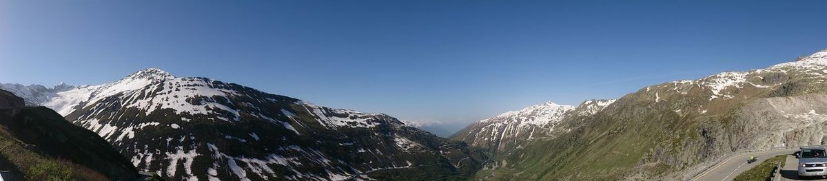 Scenic view of mountains against blue sky