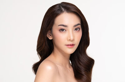 Portrait of a beautiful young woman over white background
