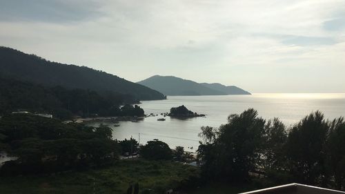 Scenic view of lake and mountains against sky