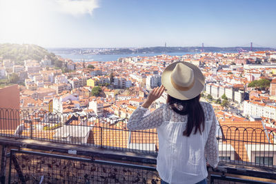 Rear view of woman looking at cityscape