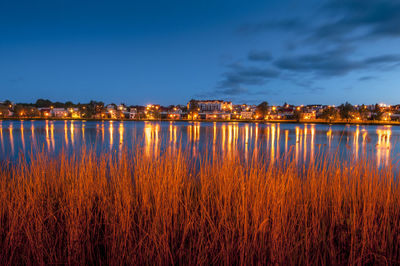 Scenic view of lake against sky at night