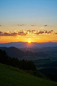 Scenic view of landscape against sky during sunset