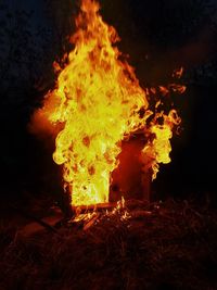 Close-up of bonfire on field at night