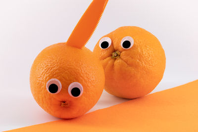 Close-up of orange fruit against white background