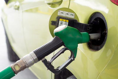 Close-up of electric car charging at gas station