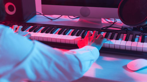 Close-up of man playing piano