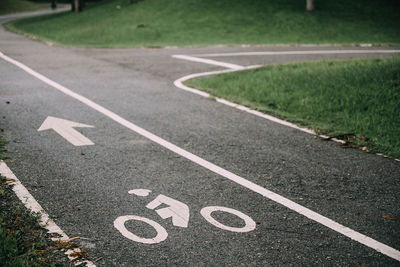 High angle view of arrow symbol on road in city