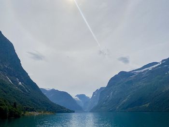 Scenic view of lake and mountains against sky