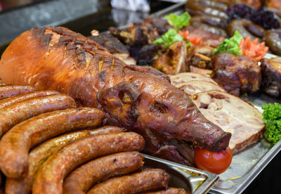 Suckling pig and sausages for sale on street food stall at christmas market in budapest, hungary