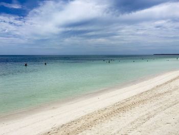 Scenic view of beach against blue sky