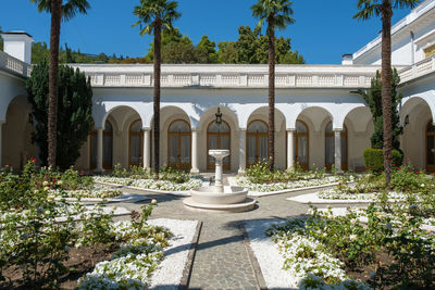 Fountain by building against sky