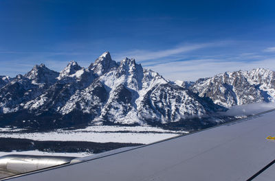 Grand teton range at eye level from an united airline flight, on approach to jackson hole, wyoming.