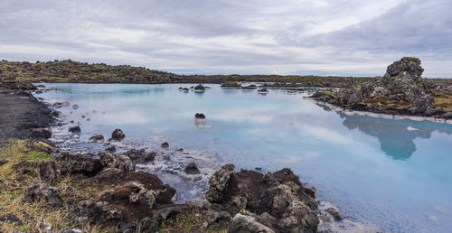 Panoramic view of rocks and trees against sky