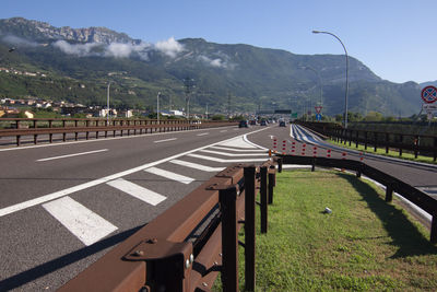 Road by mountain against sky