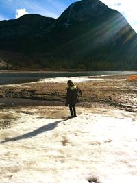 Full length of man on snow covered mountain against sky