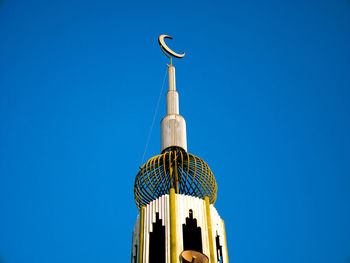 Low angle view of bell tower against blue sky