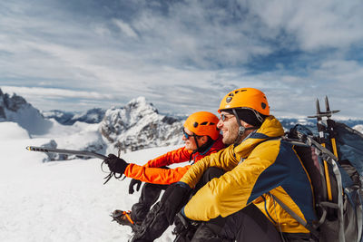 Rear view of man standing on snow covered mountain