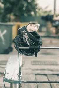 Close-up of metallic chair against city