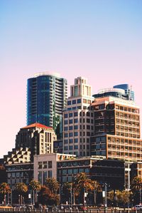 Low angle view of buildings against clear blue sky