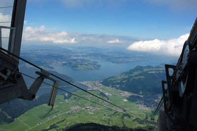 Scenic view of sea and mountains against blue sky