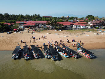 High angle view of people at beach against sky