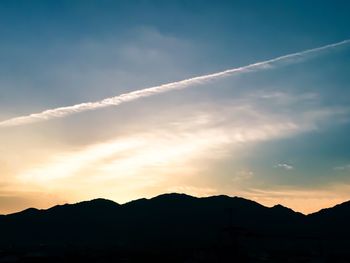 Scenic view of silhouette mountains against sky at sunset