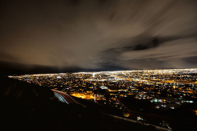 High angle view of city lit up at night