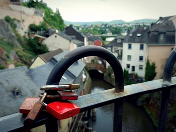 Close-up of padlocks on railing against sky