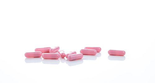 Close-up of pills over white background