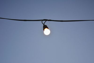 Low angle view of light bulb against clear sky