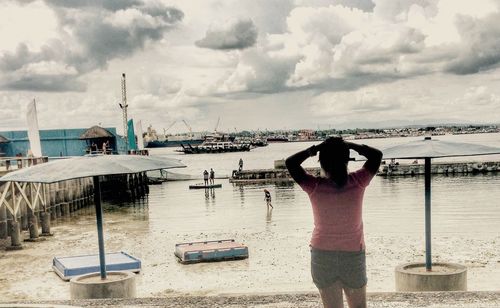 Boats in sea against cloudy sky