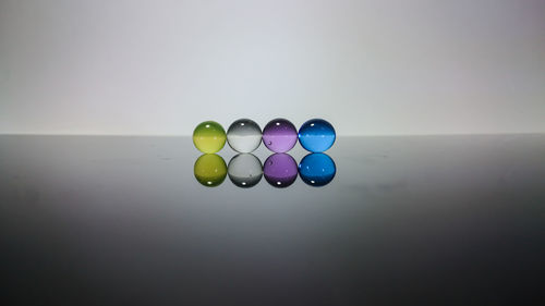 Close-up of multi colored balls on table