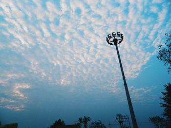 Low angle view of street light against cloudy sky