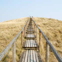 Wooden bridge on grass field