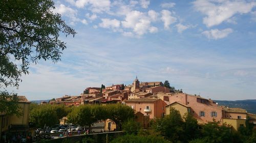 Buildings in town against sky