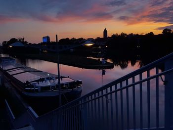 Bridge over river against sky during sunset