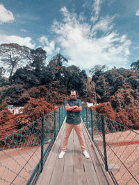 Man standing by plants against sky