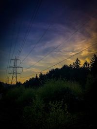 Silhouette trees on landscape against sky at sunset
