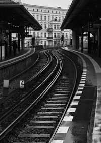 Railroad tracks amidst buildings in city