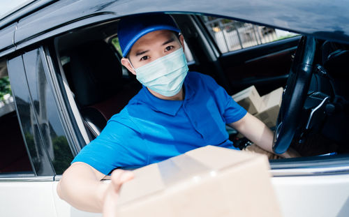 Portrait of man sitting in car