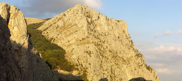 Low angle view of rock formations against sky