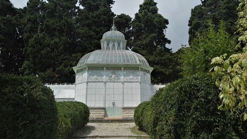 View of temple against trees and building