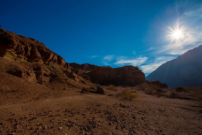 Scenic view of rocky mountains against blue sky