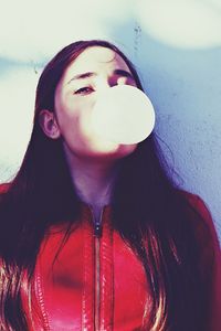 Portrait of beautiful young woman against sky