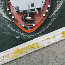 High angle view of yellow boat sailing in lake