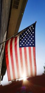 Low angle view of flag against blue sky