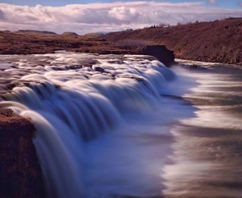 Scenic view of river flowing through rocks