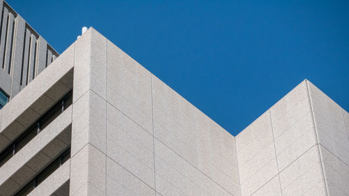 Low angle view of building against clear blue sky